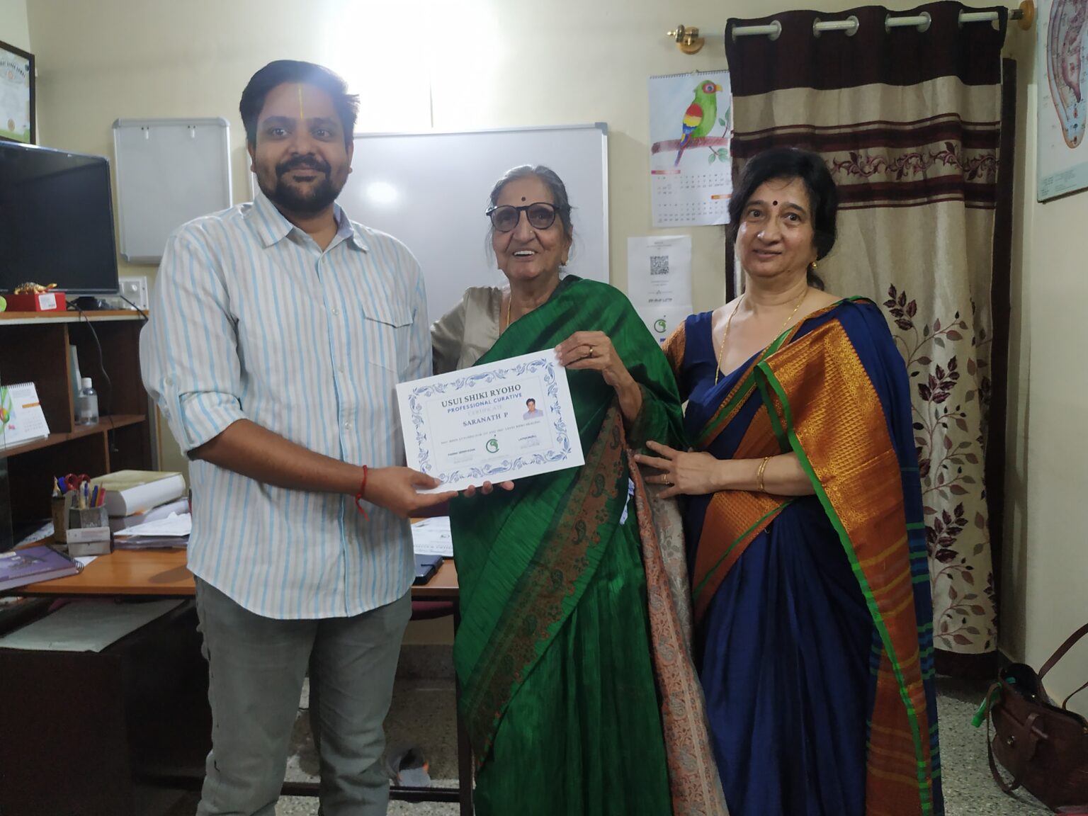 P Saranath receiving his Reiki Master certification from Smt Padma Srinivasan and Dr Latha Murli