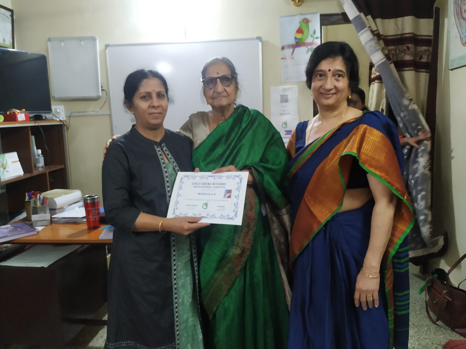 N Mangala receiving her Reiki Master certification from Smt Padma Srinivasan and Dr Latha Murli